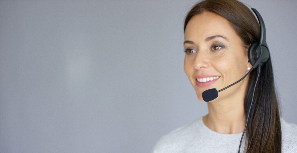 Beautiful and positive female call center agent at work